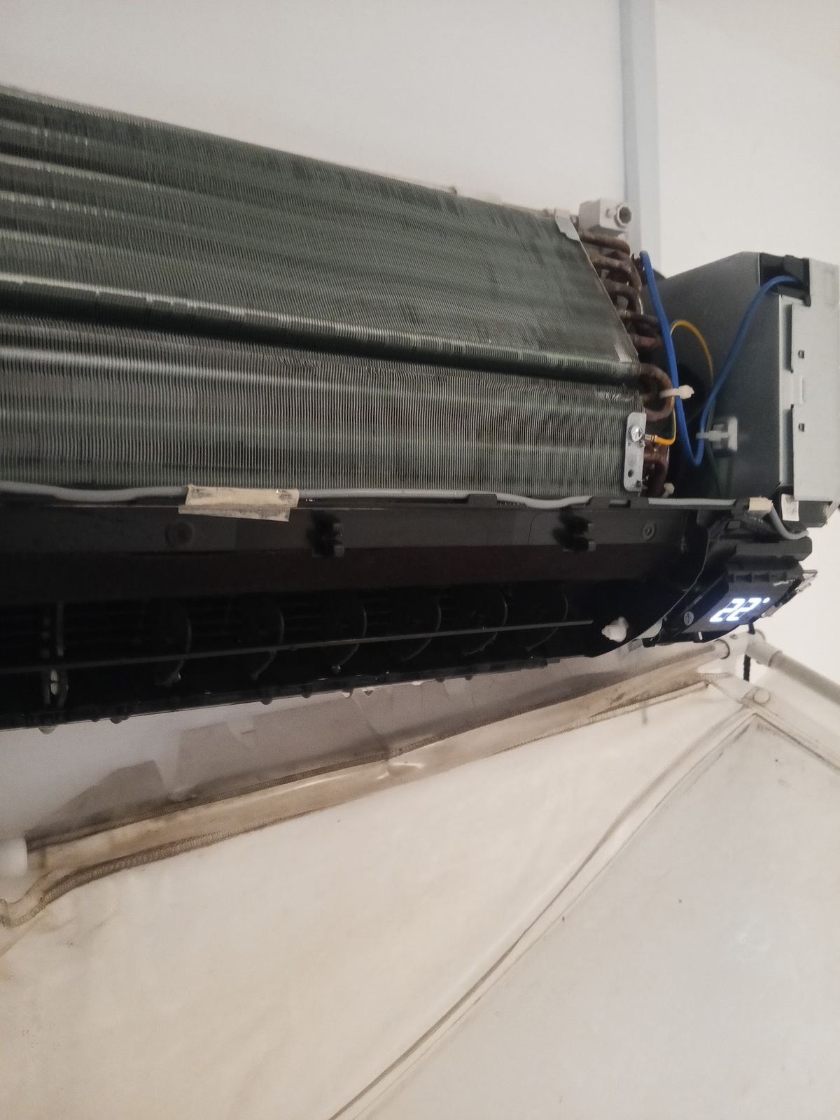Indoor unit opened for cleaning with protective sheet